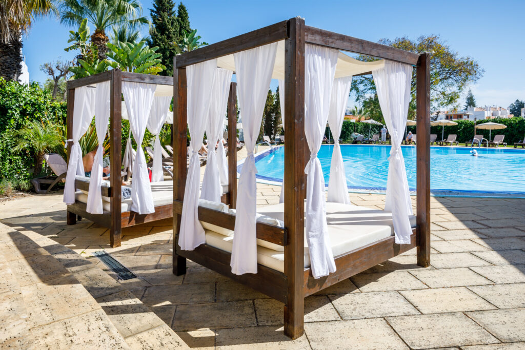 Sun beds by outdoor pool at AP Maria Nova Lounge Hotel