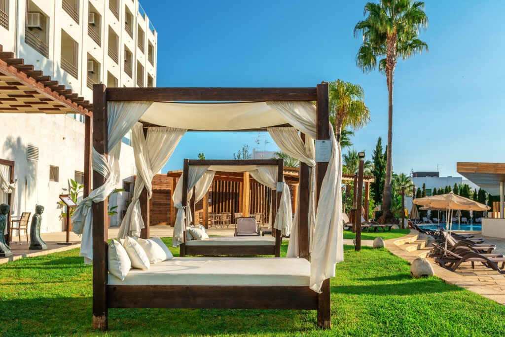 Sun beds outdoors at AP Maria Nova Lounge Hotel