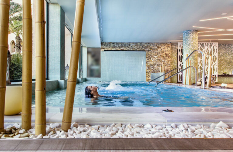 Woman relaxing in indoor pool at AR Golf Almerimar Hotel