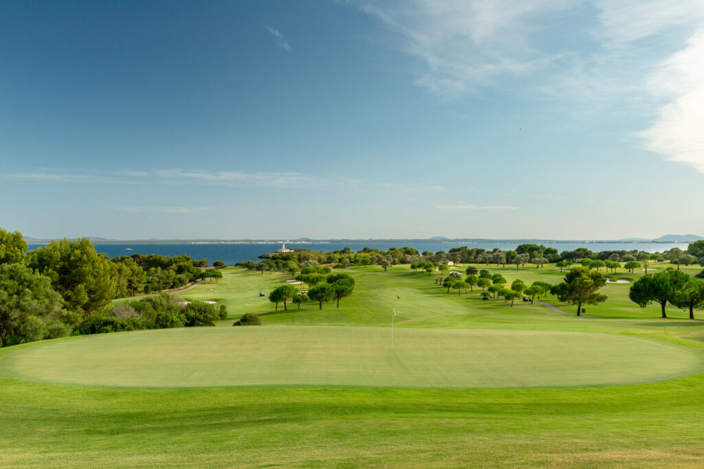 A hole at Alcanada Golf Club with fairway and lake in distance