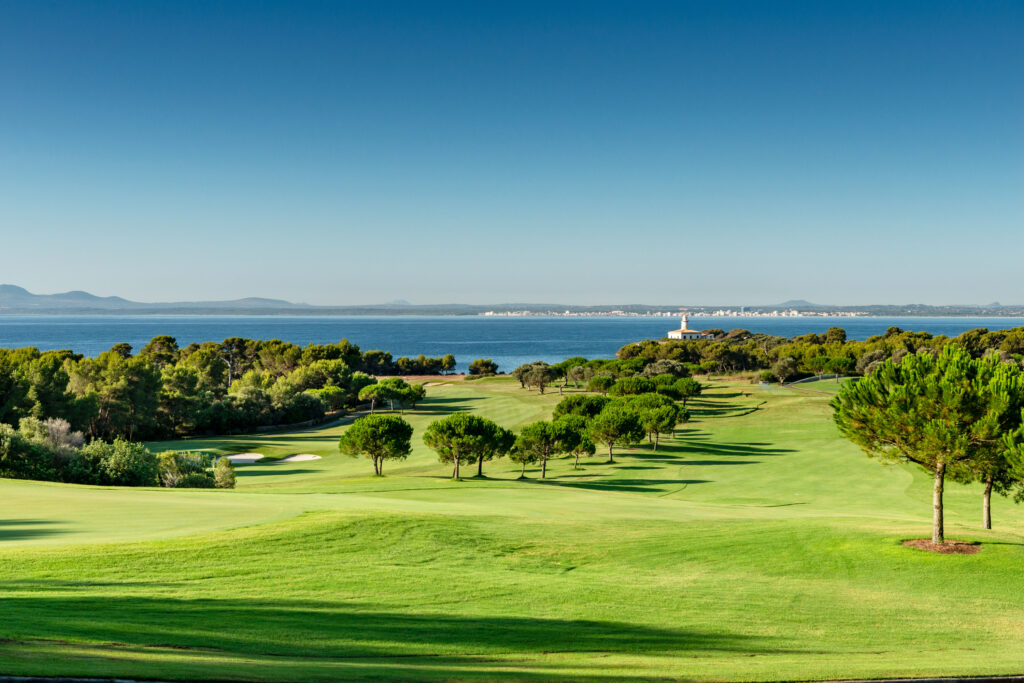 Fairway with trees around and lake in distance at Alcanada Golf Club