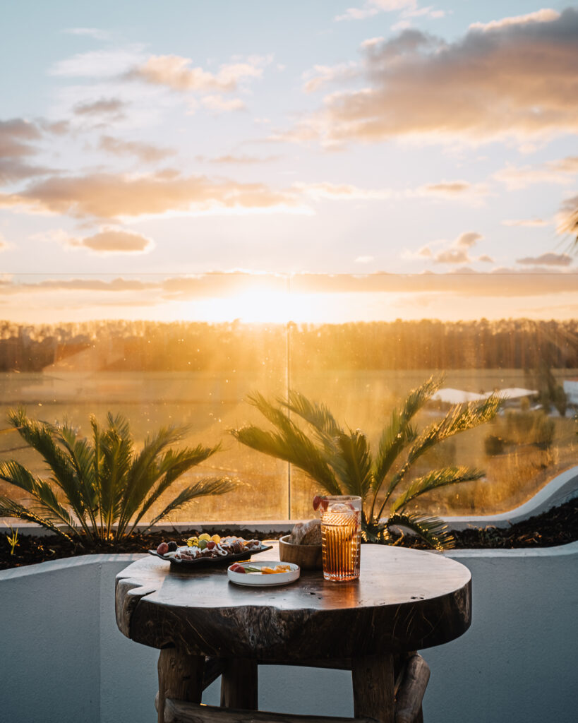 Balcony with table with food at AlmaLusa Comporta