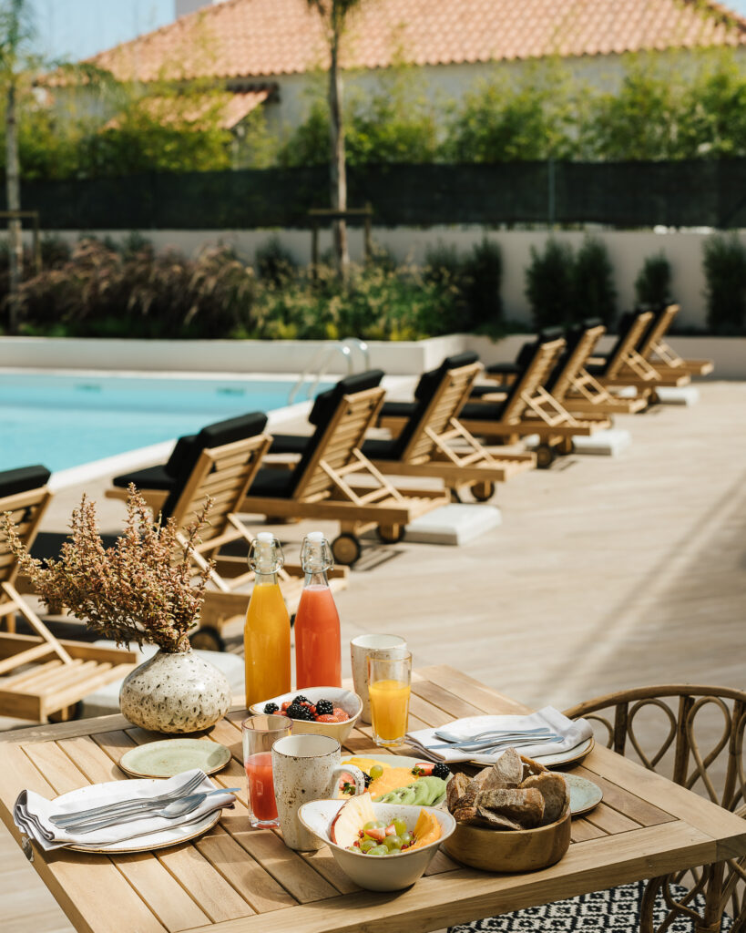 Sun loungers by outdoor pool at AlmaLusa Comporta