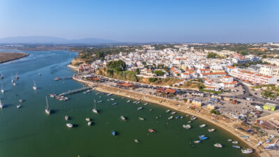 picture overview of alvor town with a river next to it