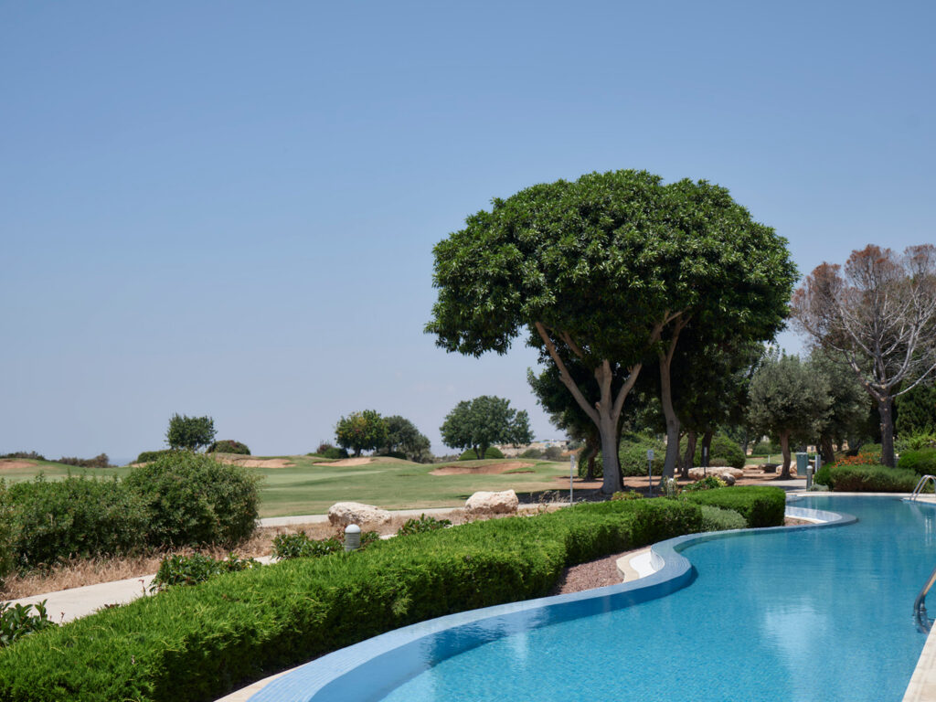 Outdoor pool with view of the golf course at Aphrodite Hills Hotel