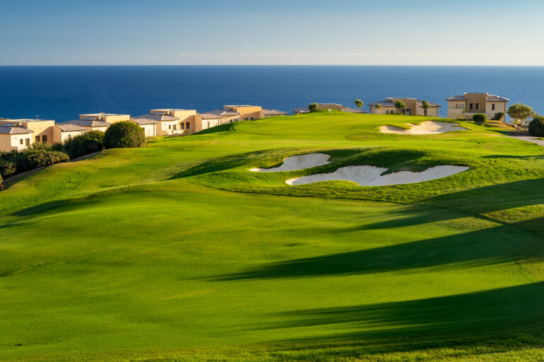 Hole with bunkers with villas around and ocean view at Aphrodite Hills PGA National Cyprus