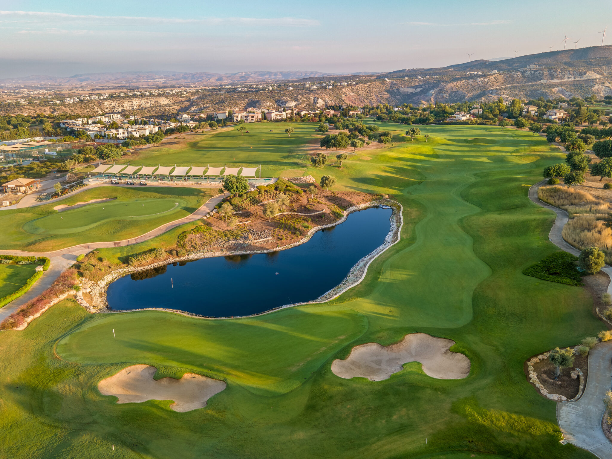 Aerial view of Aphrodite Hills PGA National Cyprus with lake on fairway