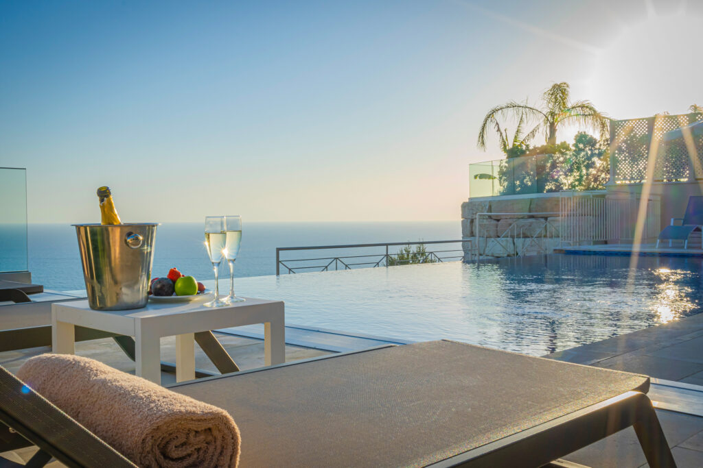 Outdoor pool with lounger and champagne at Aphrodite Hills Rentals