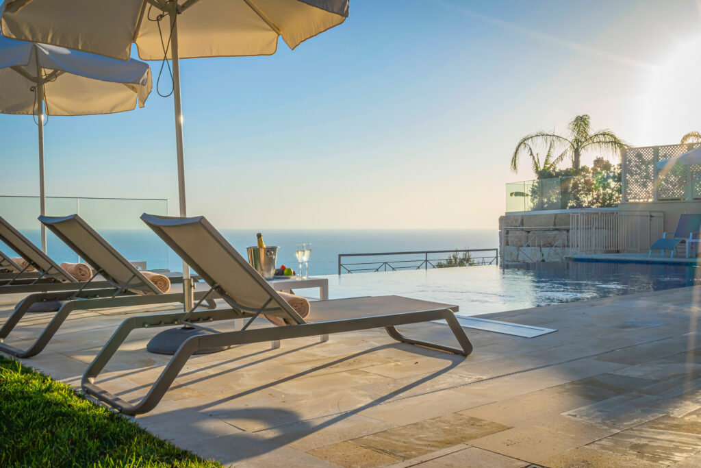 Outdoor pool with loungers at Aphrodite Hills Rentals