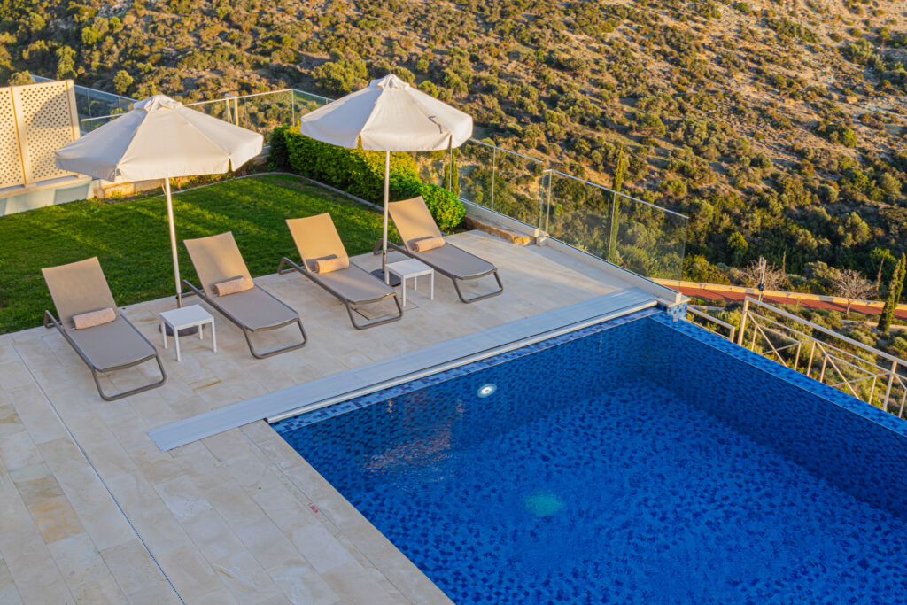 Outdoor pool with loungers at Aphrodite Hills Rentals