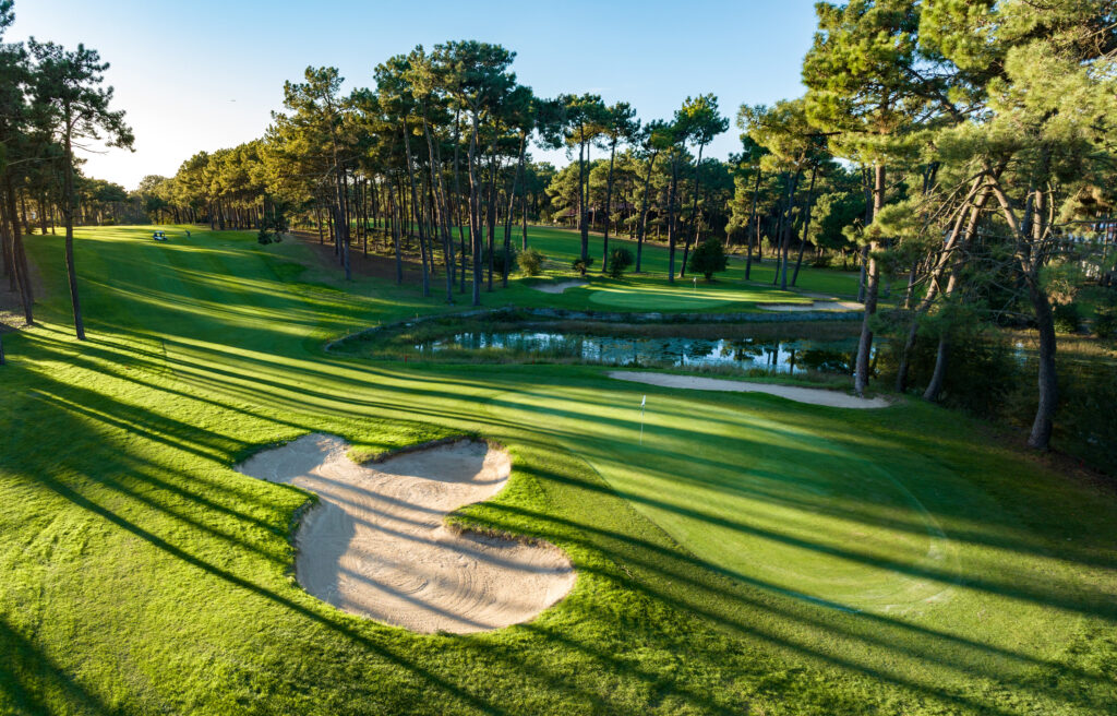 A hole with a bunker and trees at Aroeira Pines Classic Golf Course