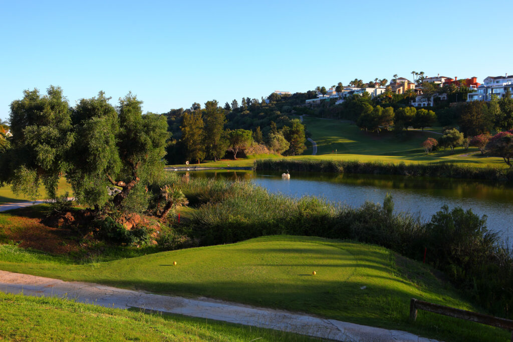 Tee box with lake and trees around at Atalaya - New Golf Course