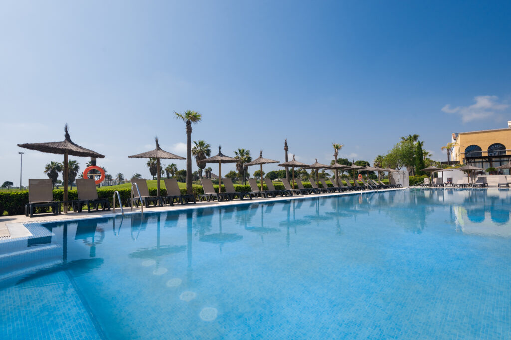 Outdoor pool with sun loungers at Barcelo Costa Ballena Golf & Spa