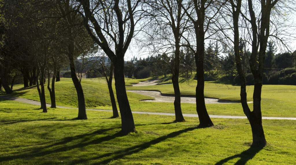 Bunker with trees in foreground at Belas Clube de Campo Golf Course