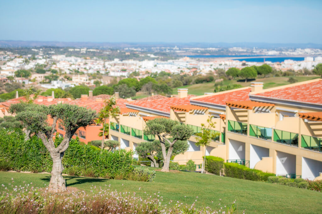 Trees wih buildings in background at Boavista Golf & Spa Resort