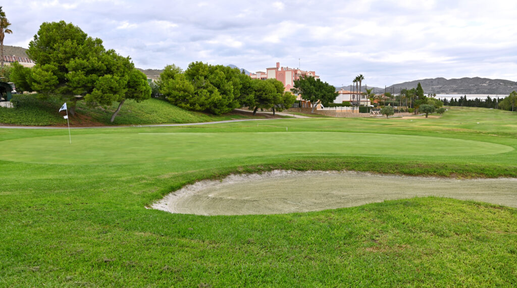 Hole with bunker at Bonalba Golf Course with trees around