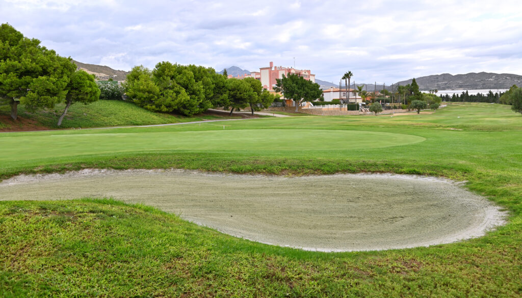 Hole with bunker at Bonalba Golf Course with trees around