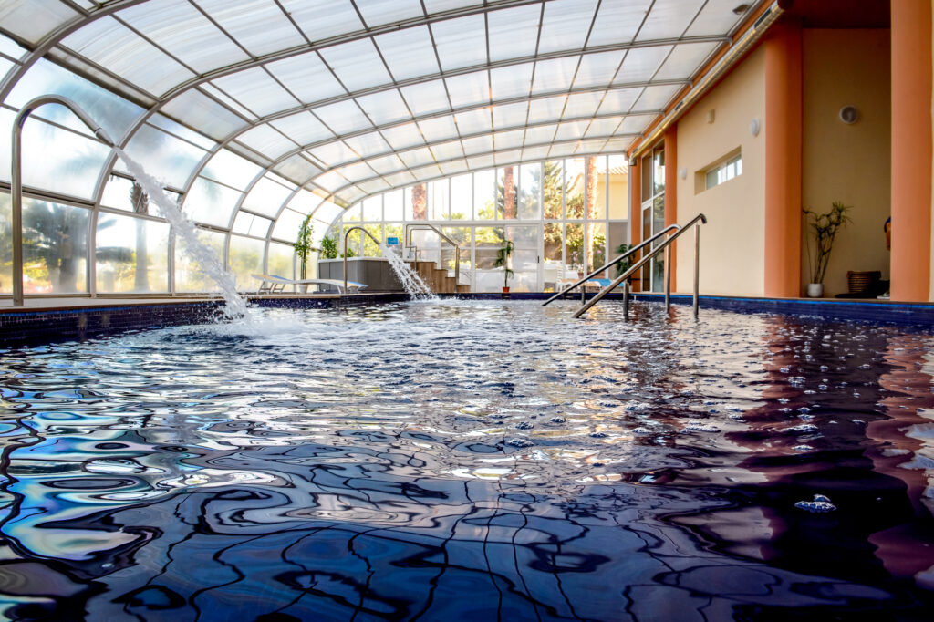 Indoor pool at Bonalba Golf Resort with water fountains