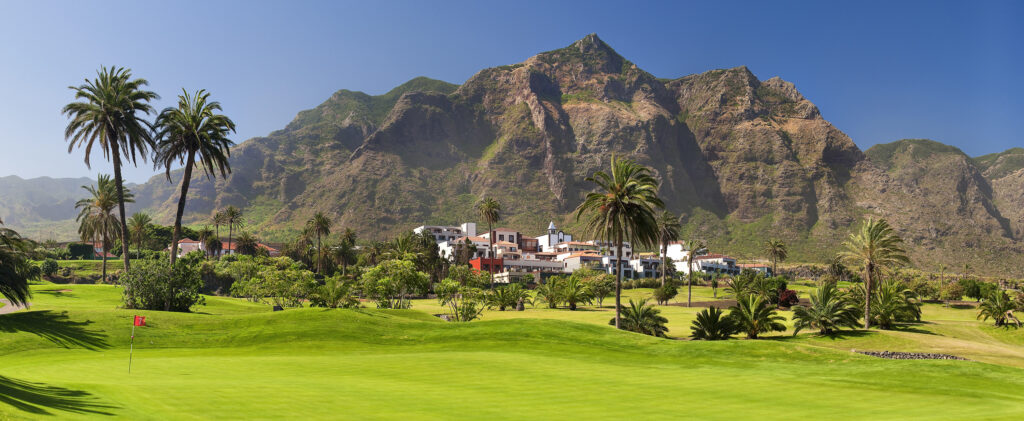 Hole with trees around with mountains in distance at Buenavista Golf Course