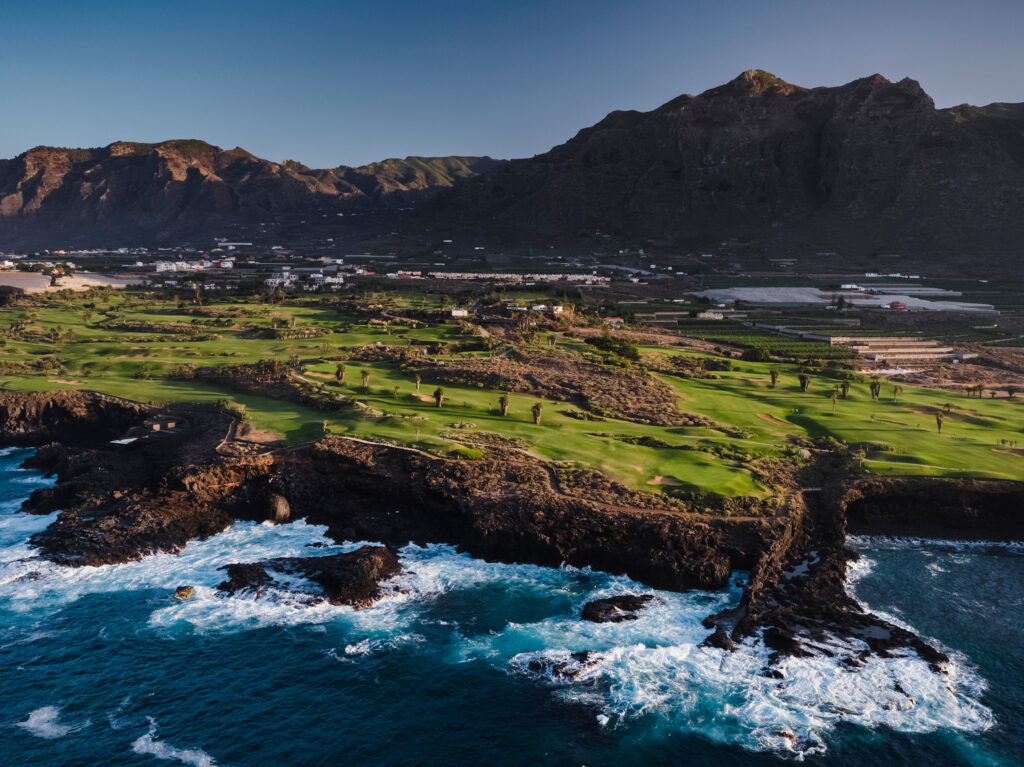 Aerial view of fairway with ocean view and mountains in distance at Buenavista Golf Course