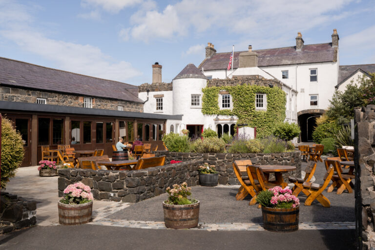 Exterior of The Bushmills Inn with outdoor seating