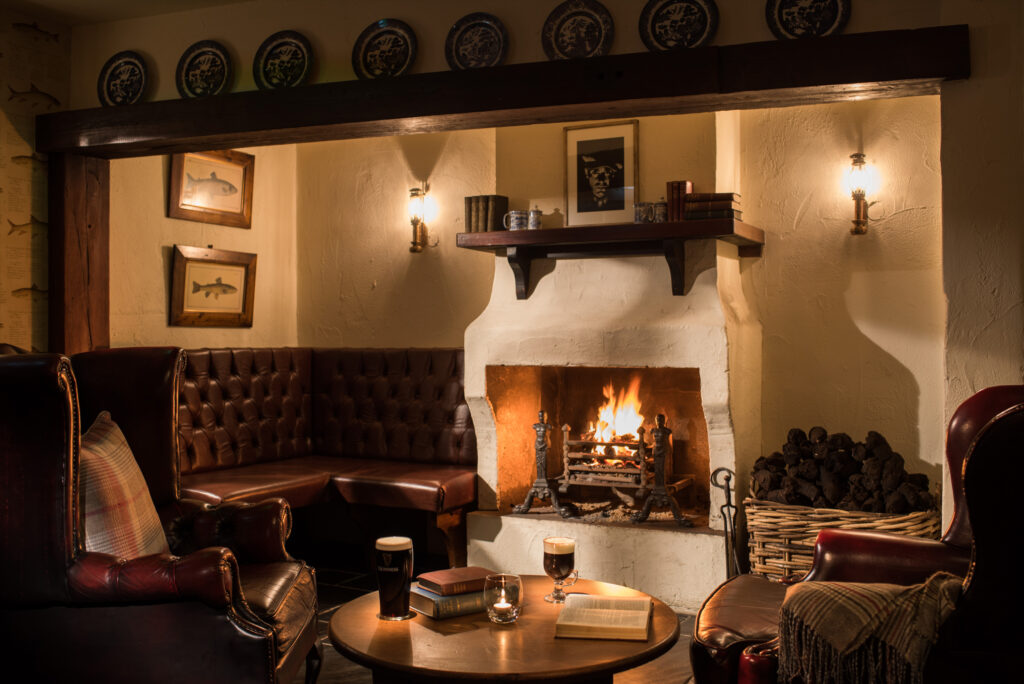 Indoor seating by fireplace at The Bushmills Inn