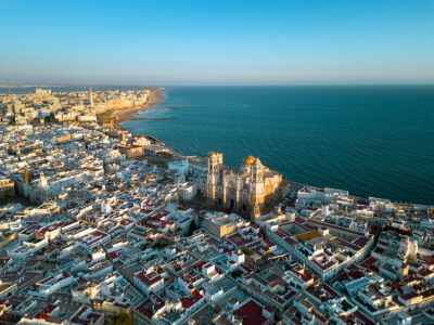 picture overview of Cadiz city with church and beach for a golf holiday