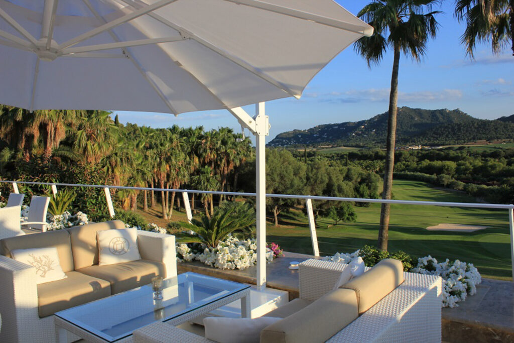 Outdoor seating overlooking the fairway at Canyamel Golf Course