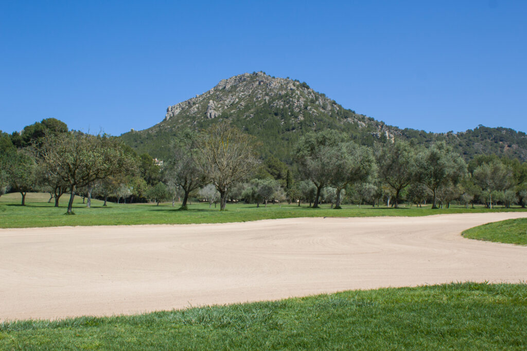 Bunker on fairway at Canyamel Golf Course with mountain in background