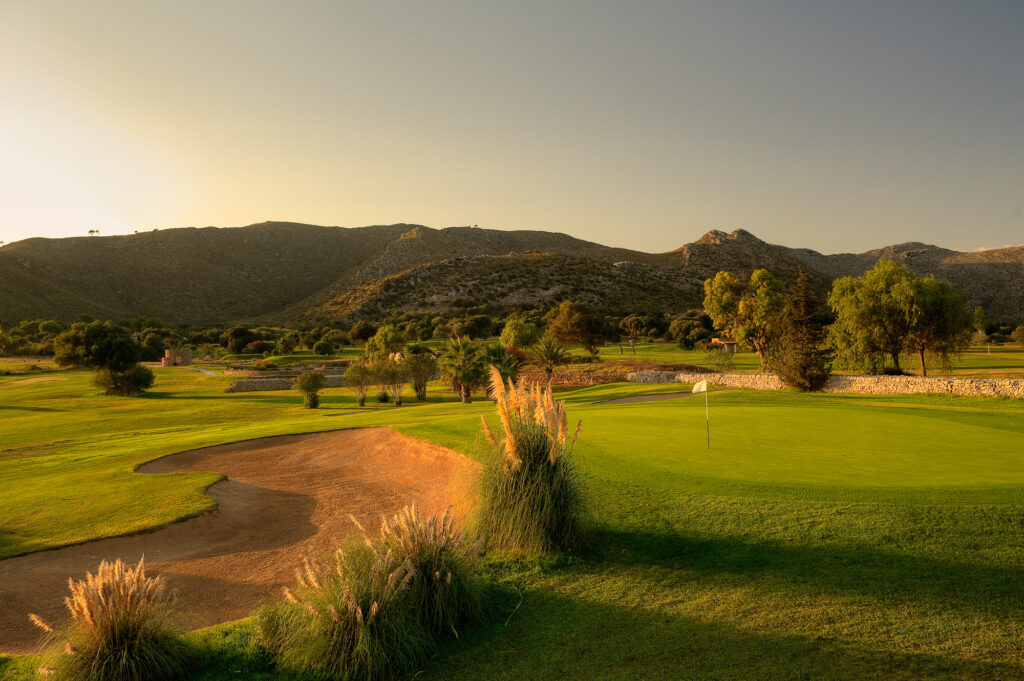 Bunkers by a hole at Capdepera Golf Course with hill in the background