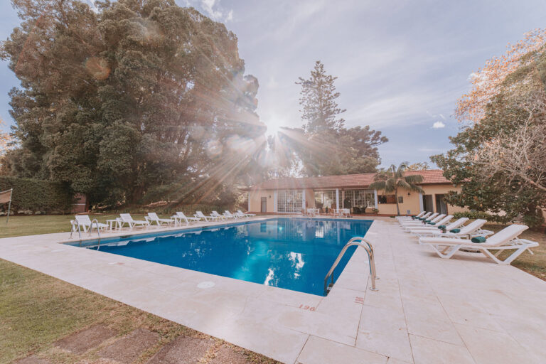Outdoor pool with sun loungers at Casa Velha Do Palheiro
