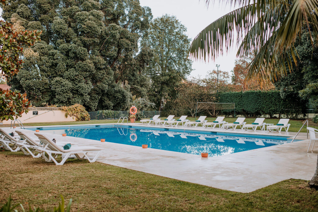 Outdoor pool with loungers at Casa Velha Do Palheiro