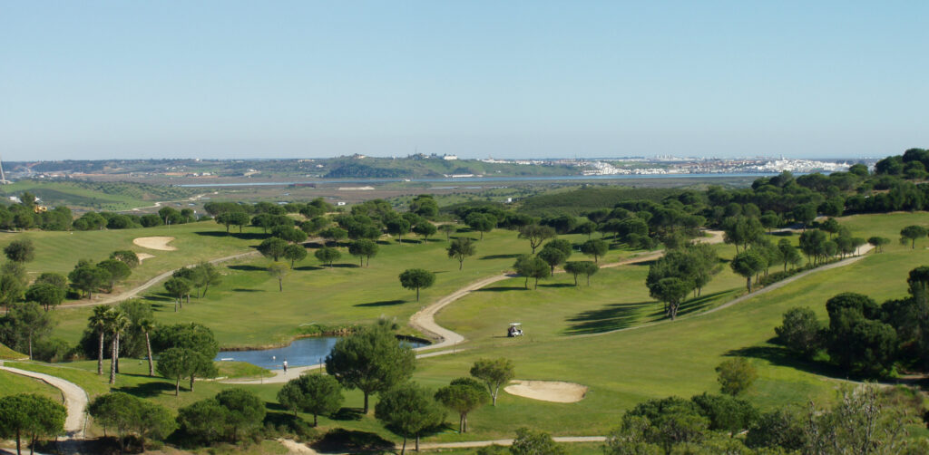 Aerial view of Castro Marim golf course with a water hazard and buggy at Castro Marim golf course