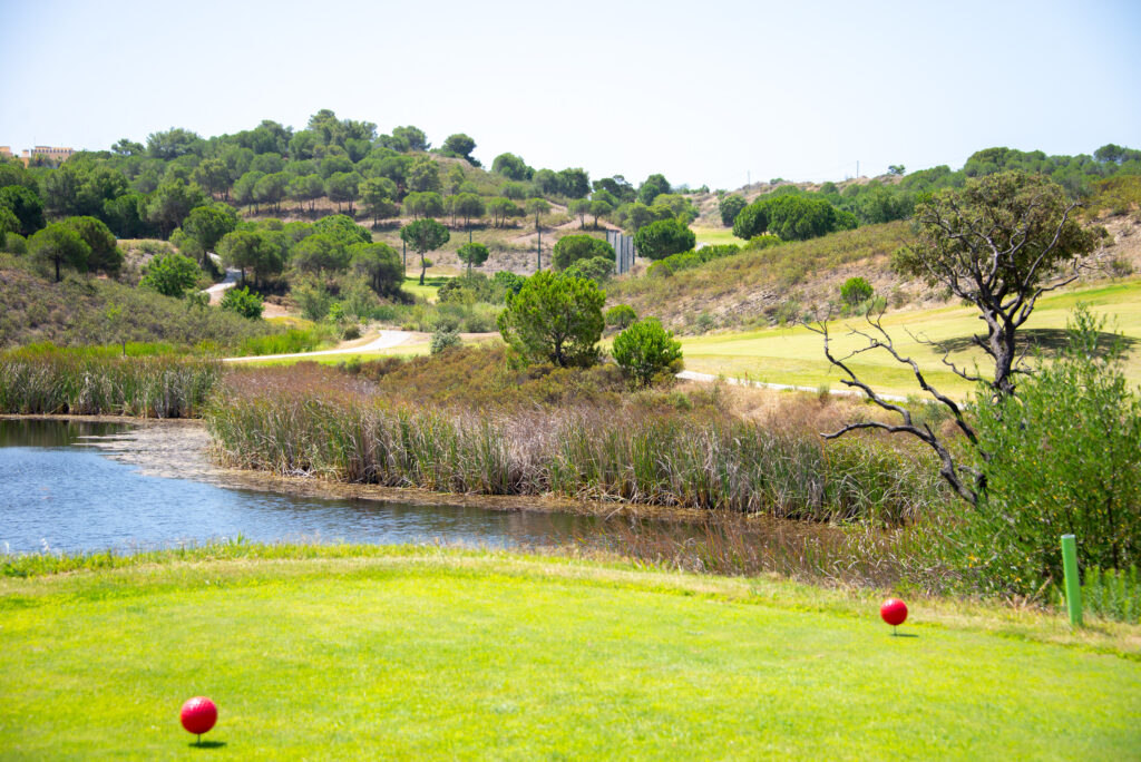 lake with shrubbery and trees around at Castro Marim golf course