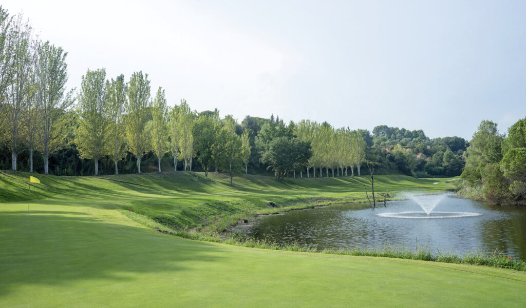 Lake with sprinkler on near a hple at Club de Golf Barcelona