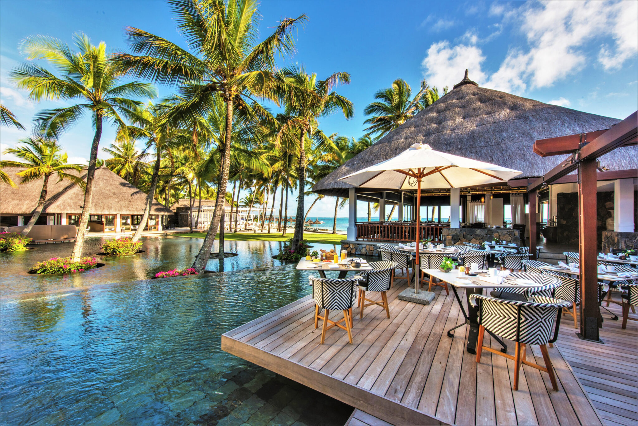 Outdoor dining at Constance Belle Mare Plage by the outdoor pool