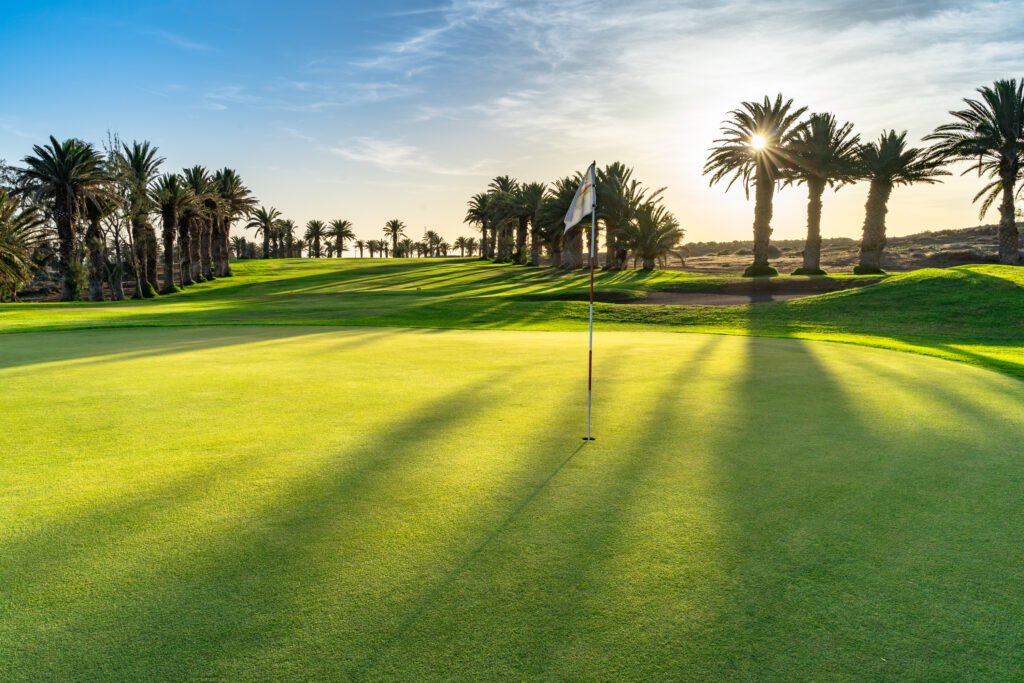 Hole with trees around and sun shining at Costa Teguise Golf