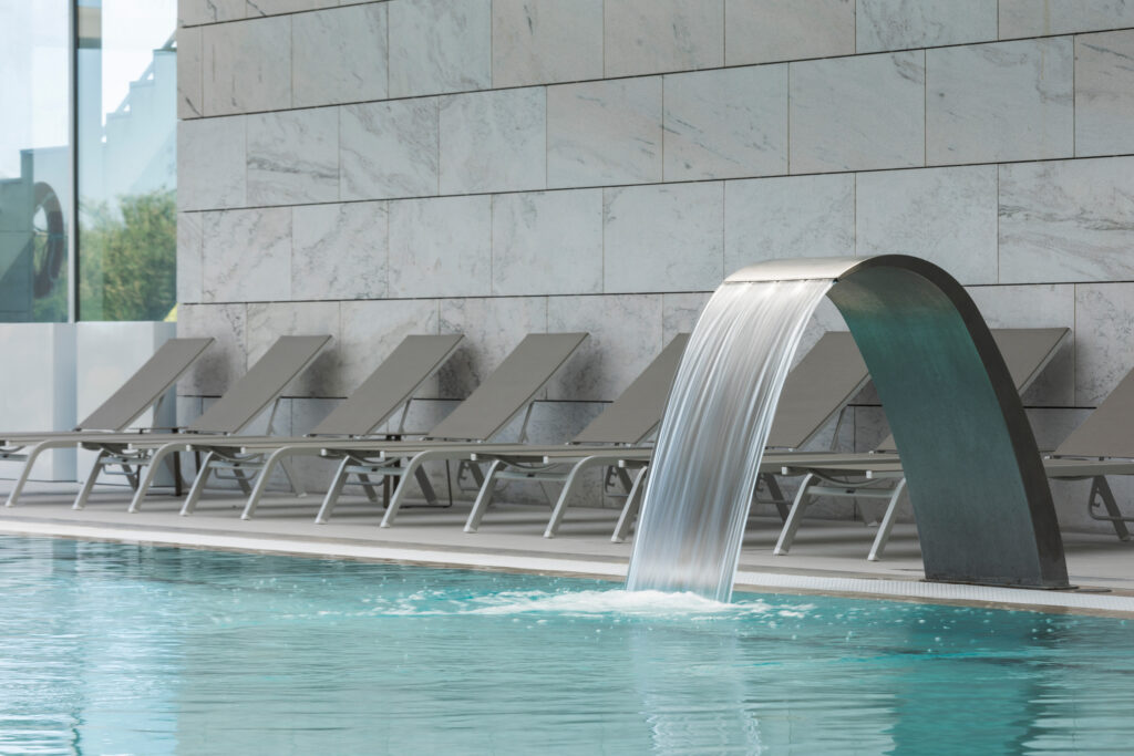 Outdoor pool with fountain at Crowne Plaza Caparica Lisbon
