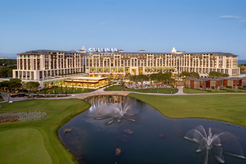 Cullinan golf course & lake views in the foreground with the grand looking Cullinan Belek Hotel in the background