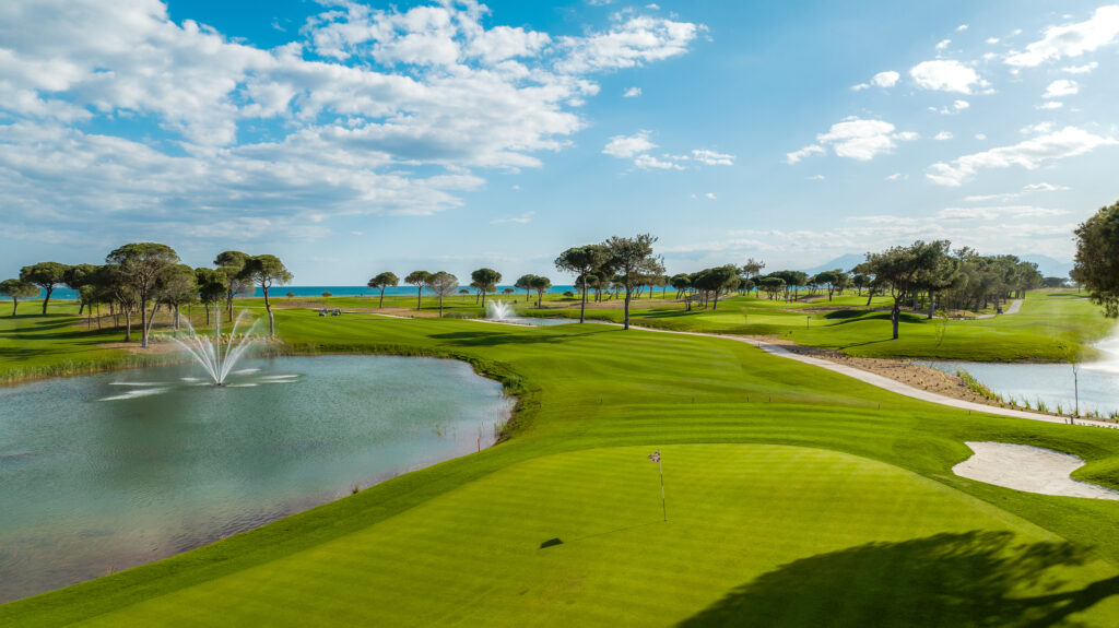 Hole with lake next to it with a fountain at Cullinan - Olympos Golf Course