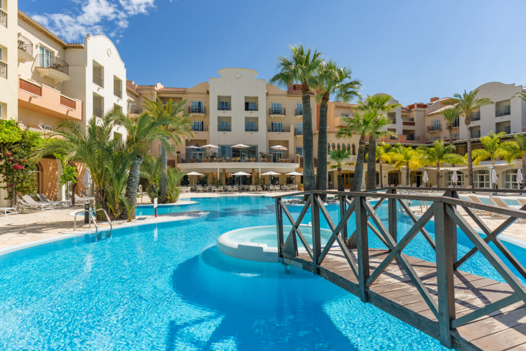 Outdoor pool with bridge at Denia La Sella Golf Resort & Spa