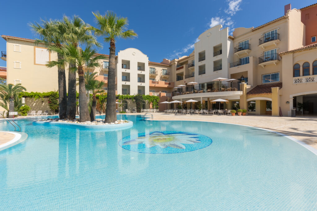 Outdoor pool and exterior of hotel at Denia La Sella Golf Resort & Spa