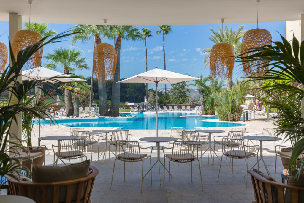 Outdoor pool and seating at Denia La Sella Golf Resort & Spa