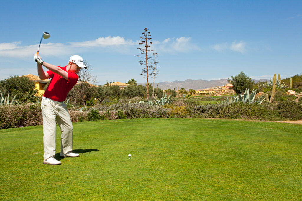 Man in red shirt playing golf at The Desert Springs Indiana Course