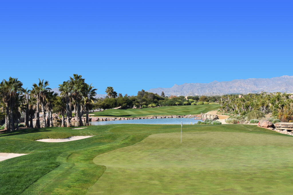 A hole with bunkers and lake in background at The Desert Springs Indiana Course