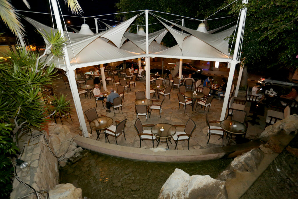 Outdoor seating area at Dionysos Central at night