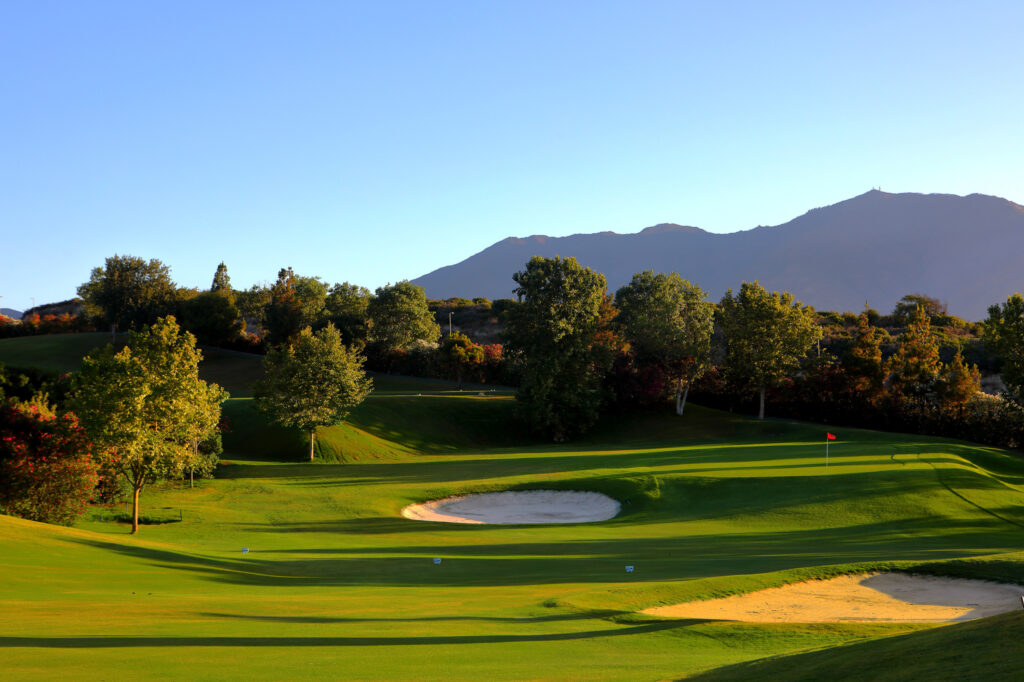 Hole with bunker and trees around at Dona Julia Golf Course