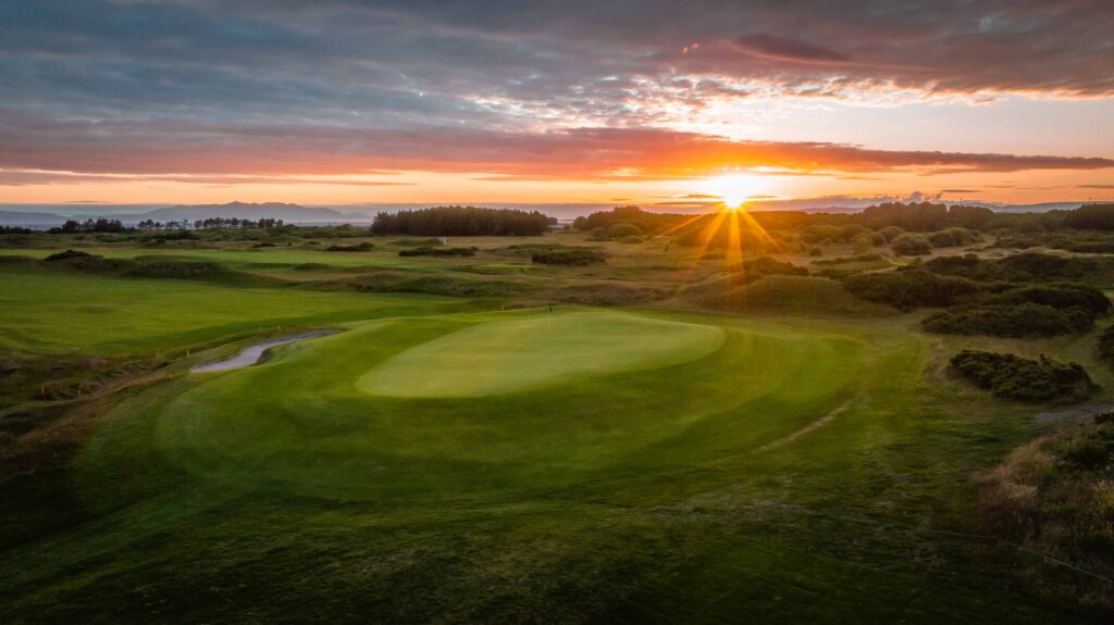 Hole at Dundonald Links with sun setting in background