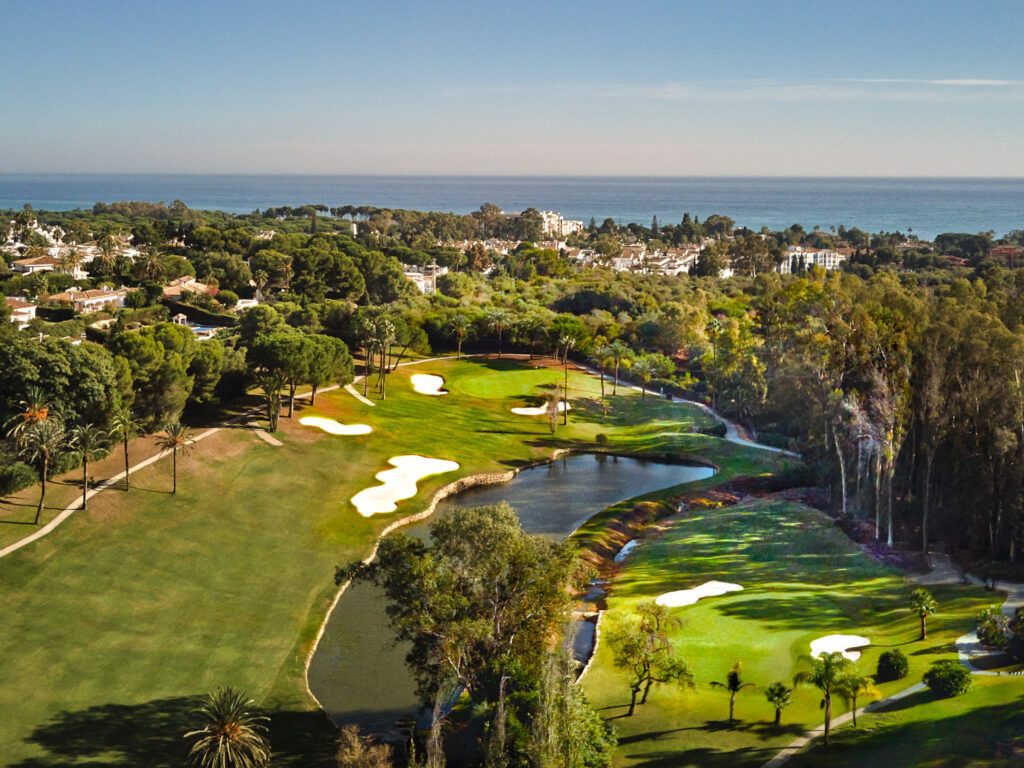 Aerial view of El Paraiso Golf Course with lake and trees around