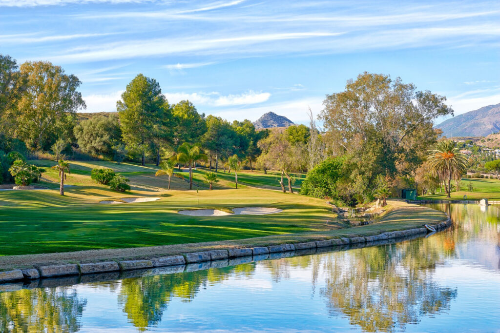 Lake with fairway and trees in background at El Paraiso Golf Course